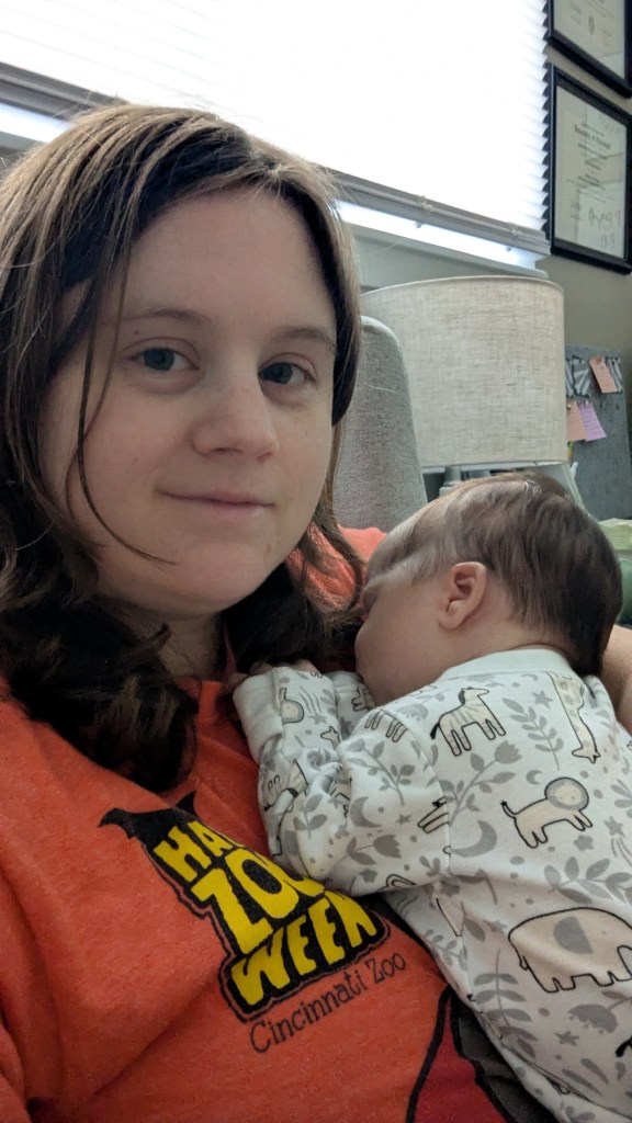 Alana with her newborn in her office